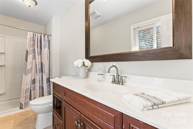 bathroom featuring tile patterned floors, vanity, curtained shower, and toilet