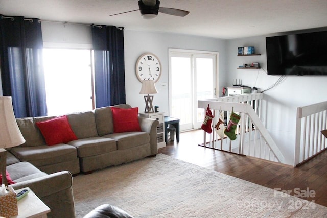 living room featuring ceiling fan and light hardwood / wood-style floors