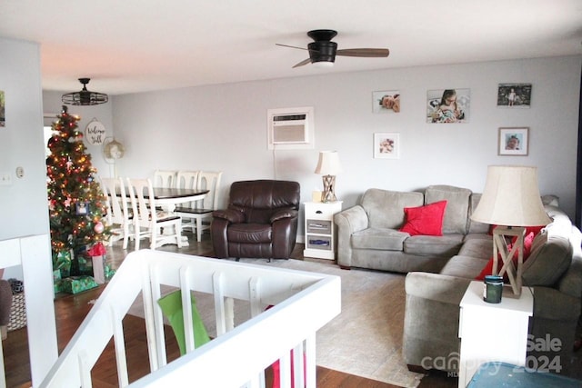living room featuring ceiling fan, a wall mounted air conditioner, and dark hardwood / wood-style floors