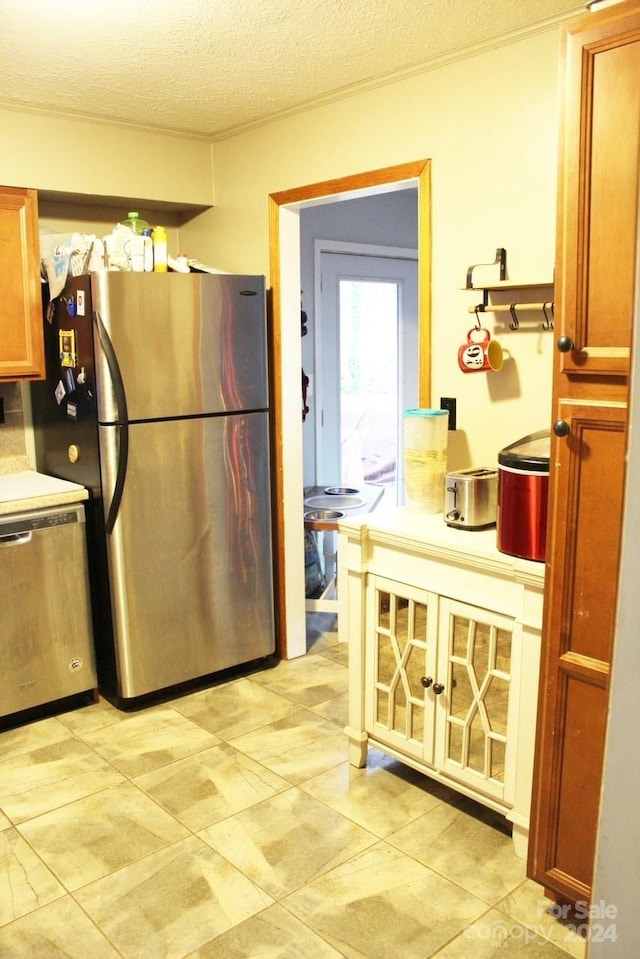 kitchen featuring a textured ceiling and appliances with stainless steel finishes