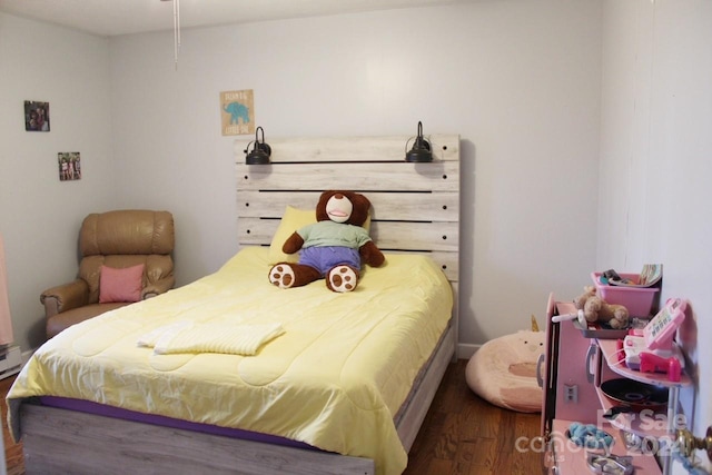 bedroom with dark wood-type flooring