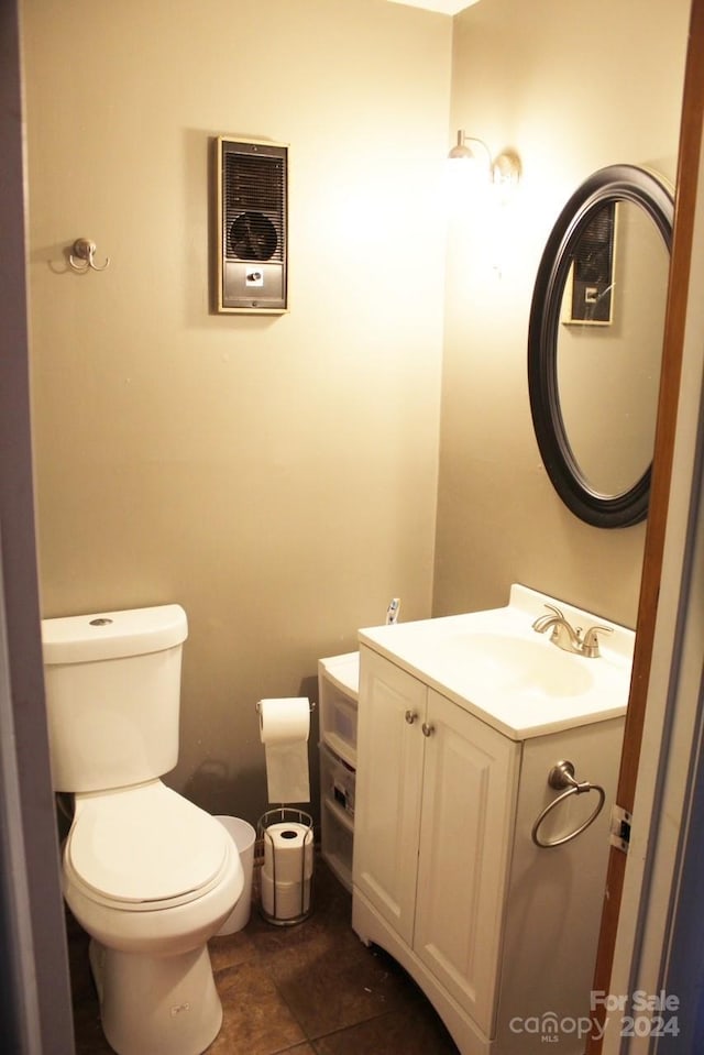 bathroom featuring tile patterned floors, vanity, and toilet