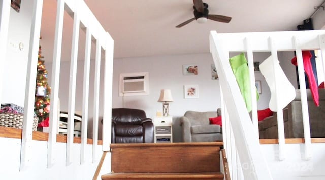 interior space with a wall mounted AC and ceiling fan