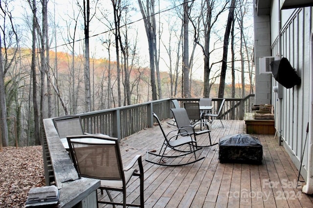 wooden deck featuring cooling unit