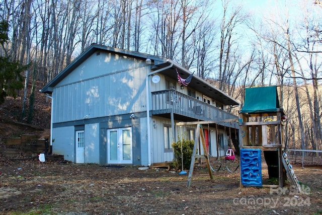 back of property featuring a trampoline