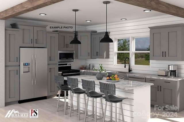 kitchen featuring pendant lighting, light hardwood / wood-style flooring, a kitchen island, beam ceiling, and stainless steel appliances