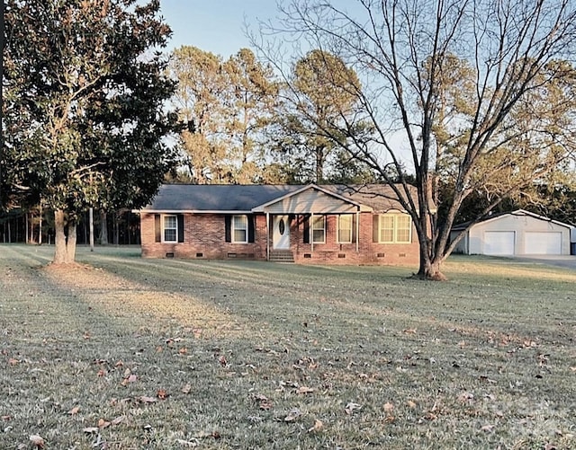 ranch-style house featuring an outbuilding and a front lawn