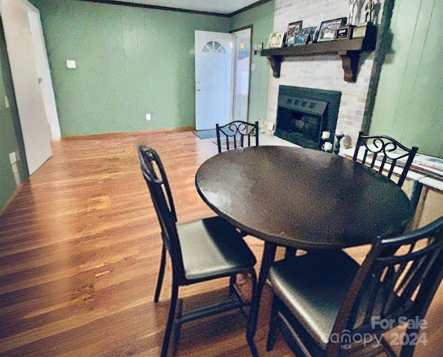 dining room featuring a fireplace and hardwood / wood-style flooring