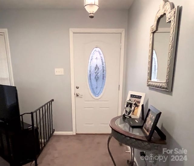 view of carpeted foyer entrance