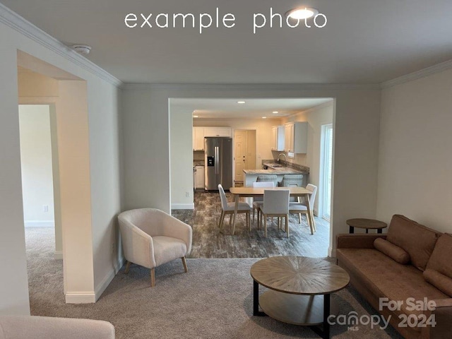 living room featuring dark carpet and ornamental molding