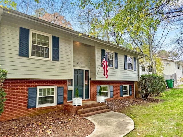 raised ranch with a front yard