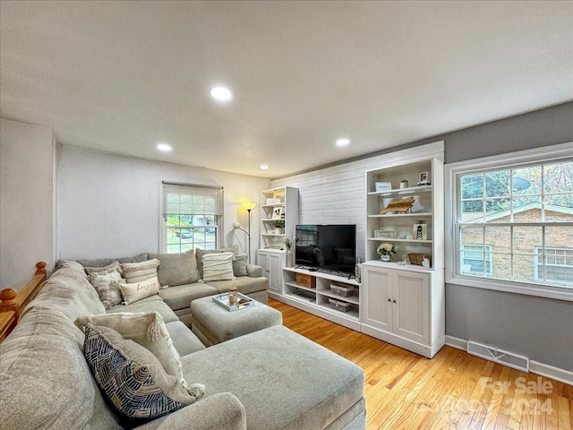 living room with a healthy amount of sunlight and light wood-type flooring