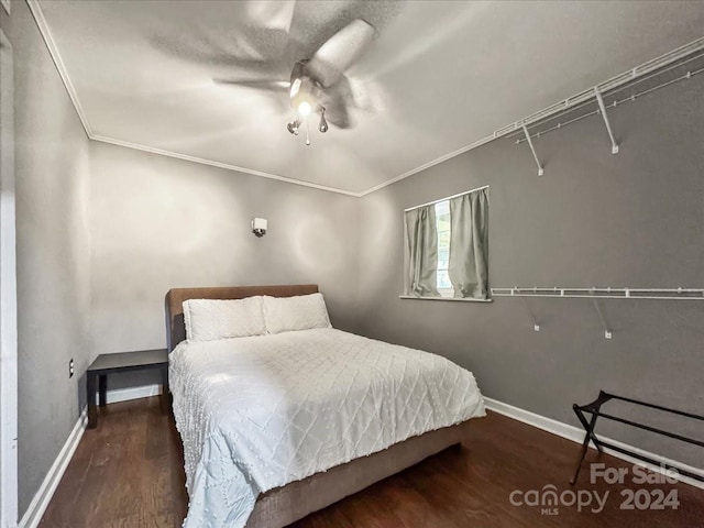 bedroom featuring ceiling fan, dark hardwood / wood-style floors, and ornamental molding