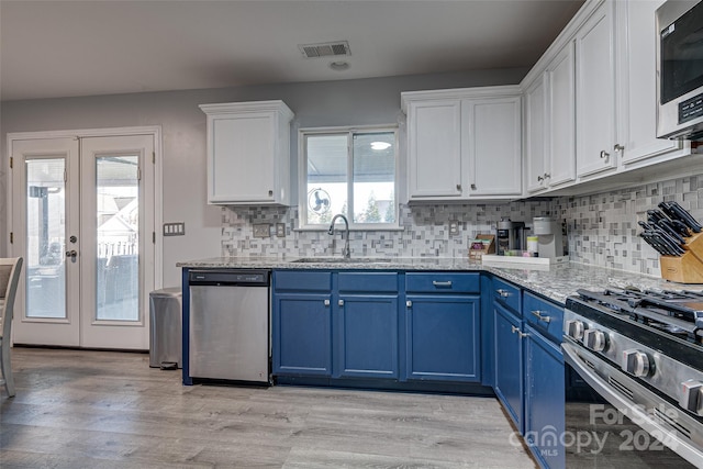 kitchen featuring a wealth of natural light, sink, french doors, blue cabinets, and appliances with stainless steel finishes