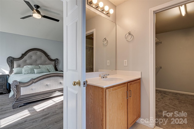 bathroom with vanity, hardwood / wood-style flooring, and ceiling fan