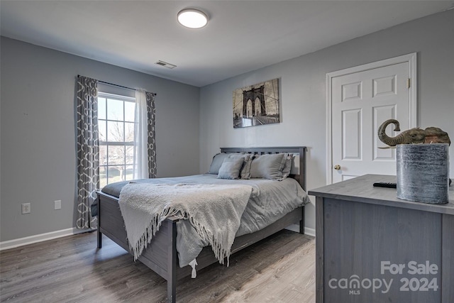 bedroom with wood-type flooring