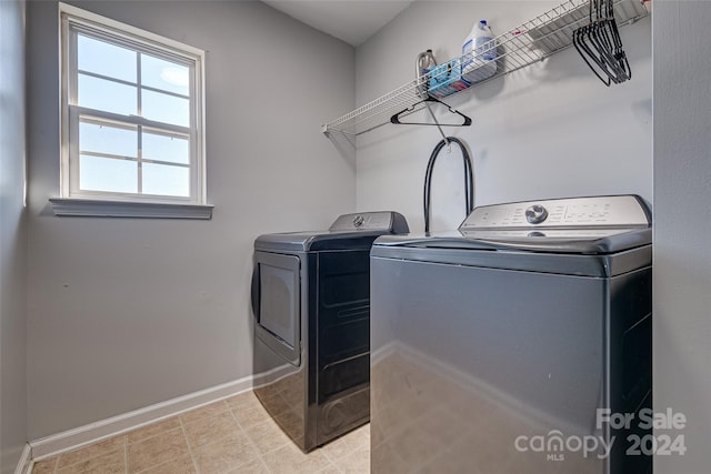 clothes washing area featuring washer and clothes dryer