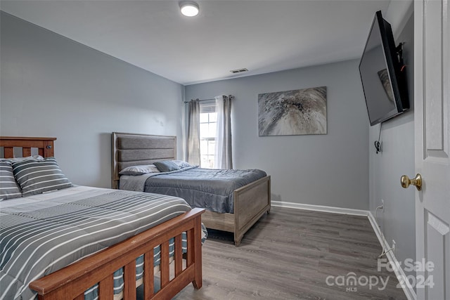 bedroom with wood-type flooring