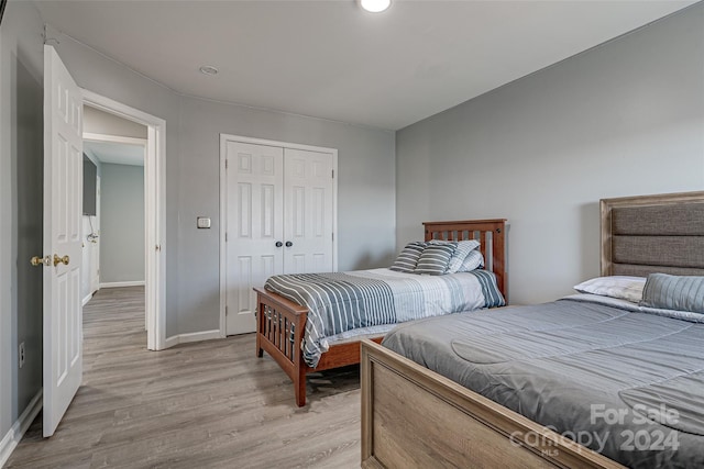 bedroom featuring a closet and light hardwood / wood-style flooring