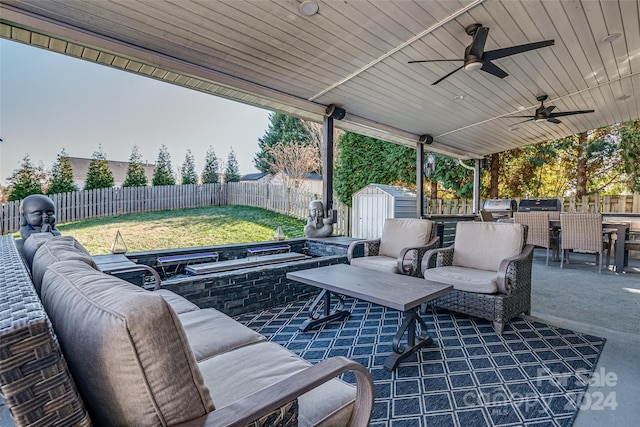 view of patio / terrace with area for grilling, outdoor lounge area, and a storage unit