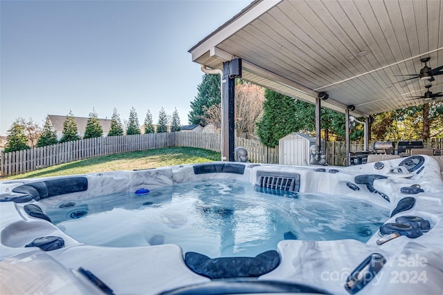 view of pool featuring a hot tub and ceiling fan