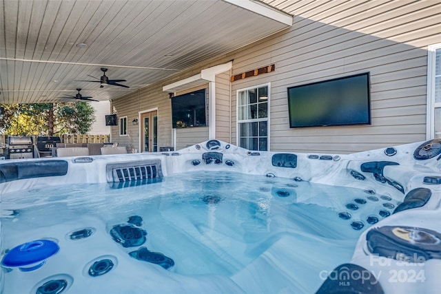 view of patio / terrace featuring a hot tub and ceiling fan