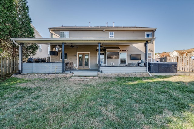 back of house with a lawn, ceiling fan, french doors, and a patio