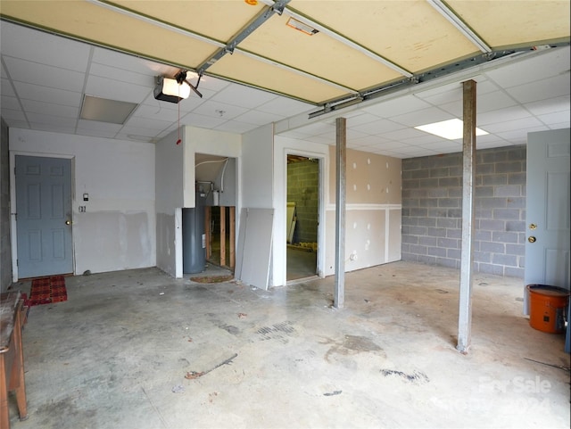 garage featuring a garage door opener and water heater