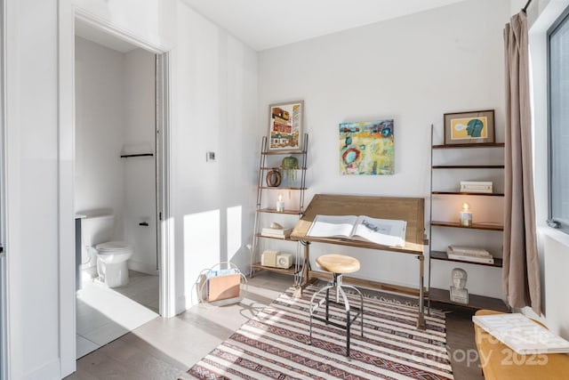 sitting room with wood-type flooring