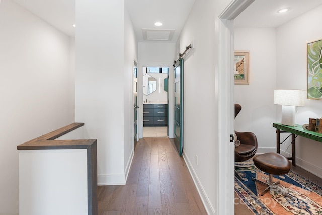 hall with dark hardwood / wood-style flooring and a barn door