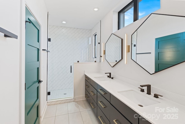 bathroom featuring tile patterned floors, a shower with door, tile walls, and vanity