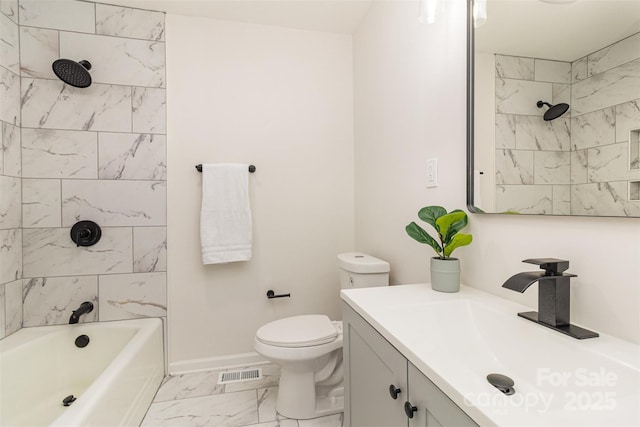 full bathroom with vanity, tiled shower / bath combo, and toilet