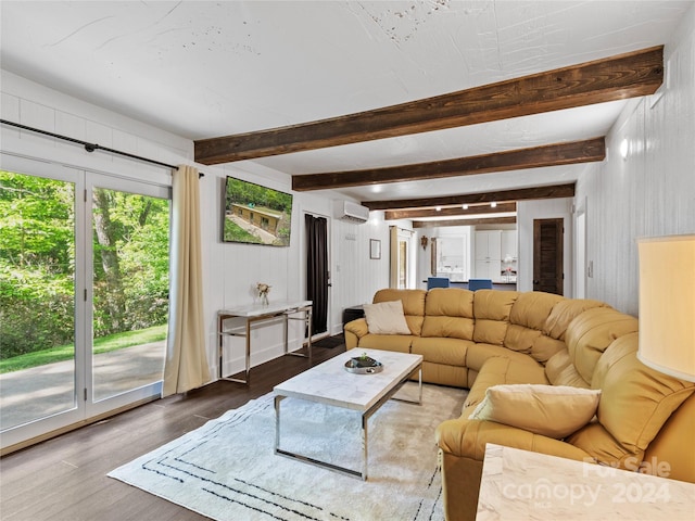 living room featuring beam ceiling, dark hardwood / wood-style flooring, and a wall mounted air conditioner