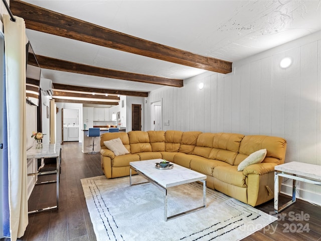 living room featuring beam ceiling, wooden walls, washer / clothes dryer, and dark wood-type flooring