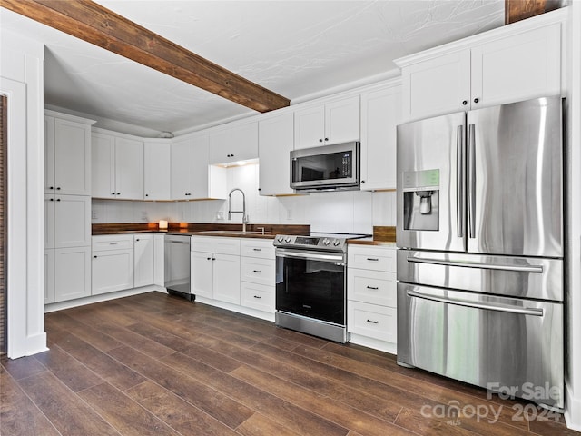 kitchen featuring white cabinets, appliances with stainless steel finishes, dark wood-type flooring, and sink