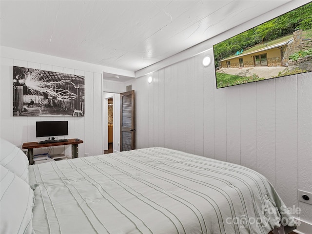 bedroom with wooden walls