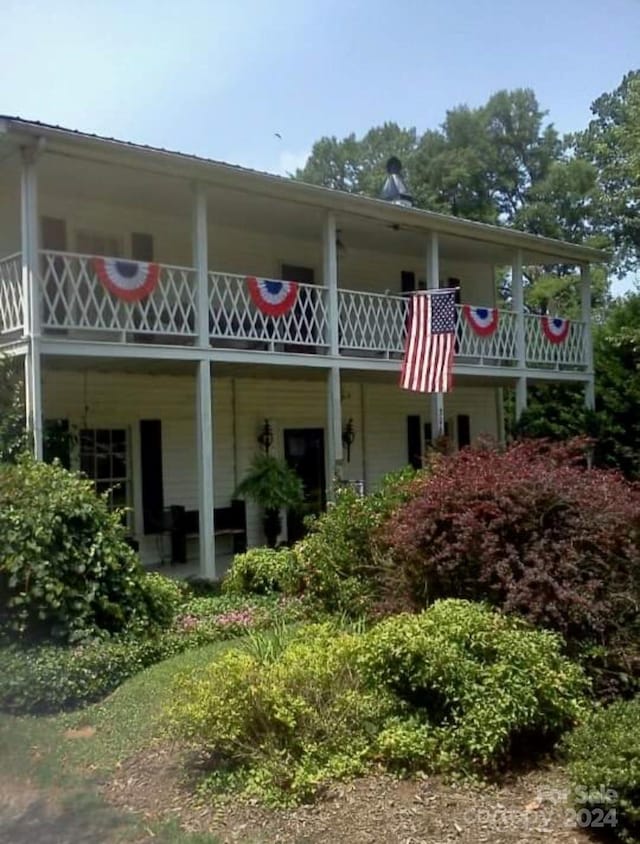 back of house with a balcony