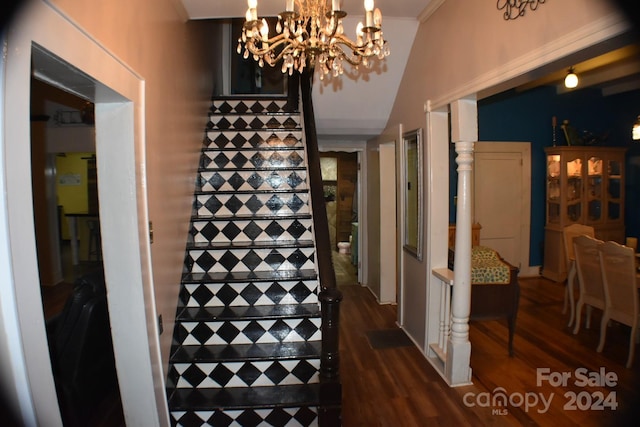 interior space featuring a notable chandelier, wood-type flooring, ornamental molding, and tile walls