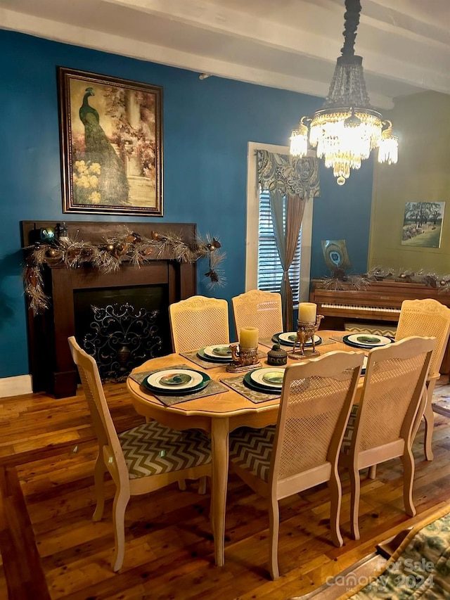 dining space with hardwood / wood-style floors and a notable chandelier