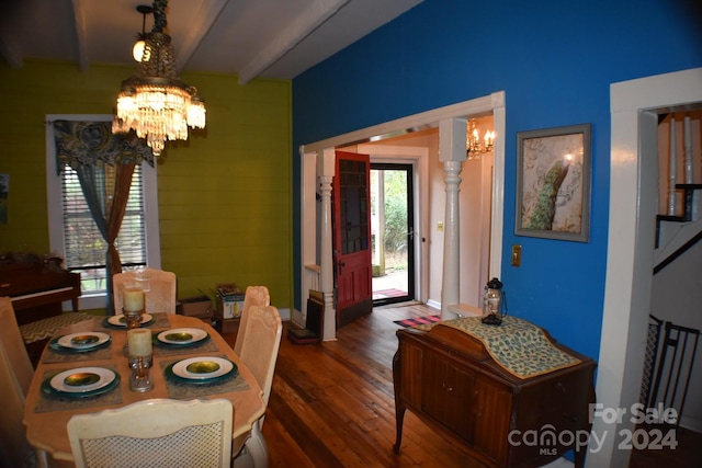 dining space featuring beam ceiling, a healthy amount of sunlight, dark wood-type flooring, and a chandelier