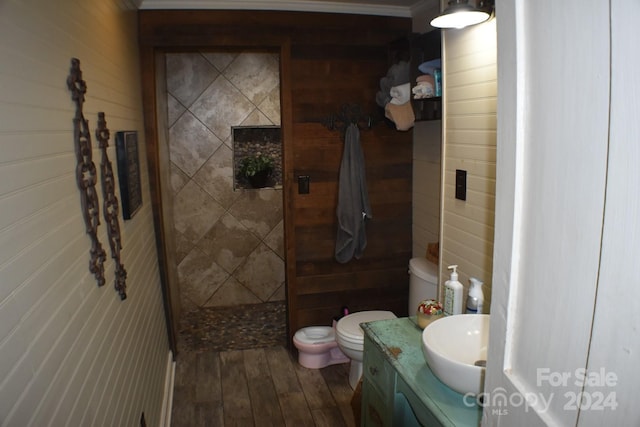 306 Mcadenville Rd, Lowell, NC 28098 - full bathroom featuring vanity, a tile shower, and wood-type flooring