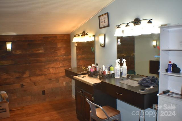 bathroom featuring hardwood / wood-style floors, crown molding, wooden walls, and vaulted ceiling