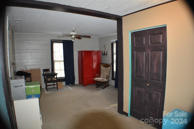 interior space with beam ceiling and ceiling fan