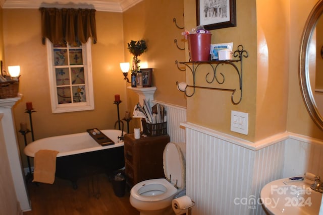 bathroom with a washtub, hardwood / wood-style flooring, toilet, and ornamental molding