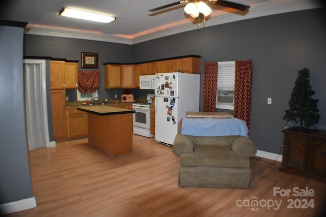 kitchen with light wood-type flooring, white appliances, and crown molding