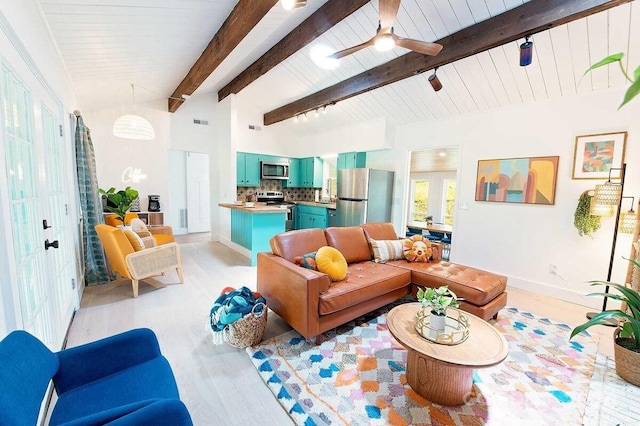 living room featuring lofted ceiling with beams, light hardwood / wood-style flooring, and ceiling fan