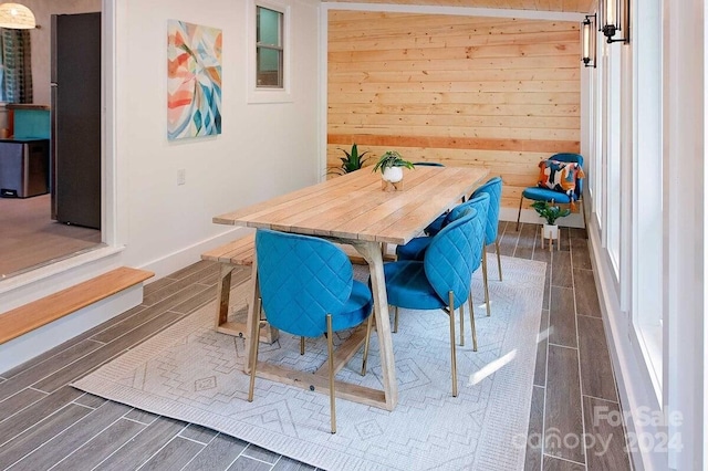 dining room featuring wood walls