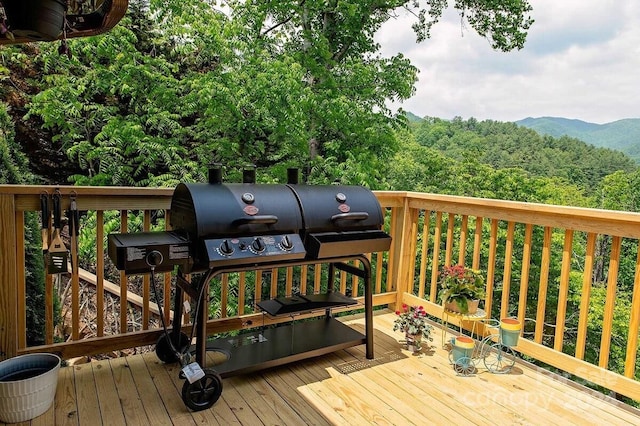 deck featuring a mountain view and area for grilling