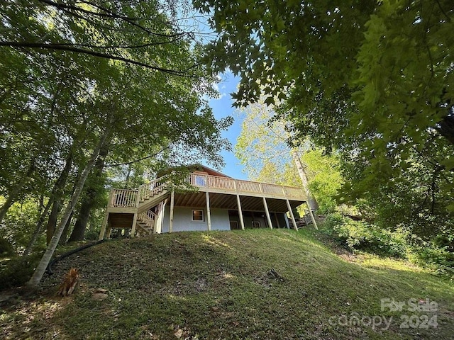 back of house with a deck