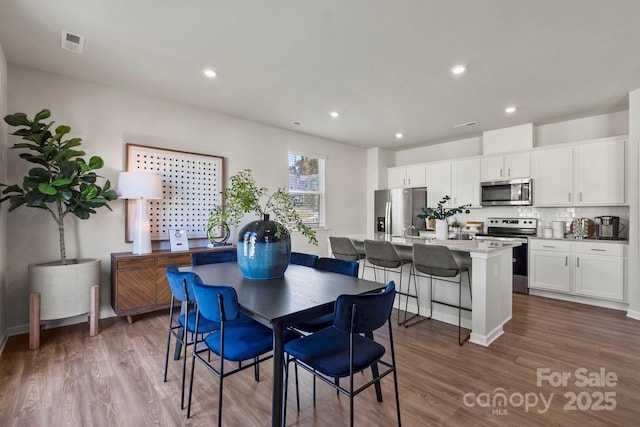 dining room with hardwood / wood-style flooring